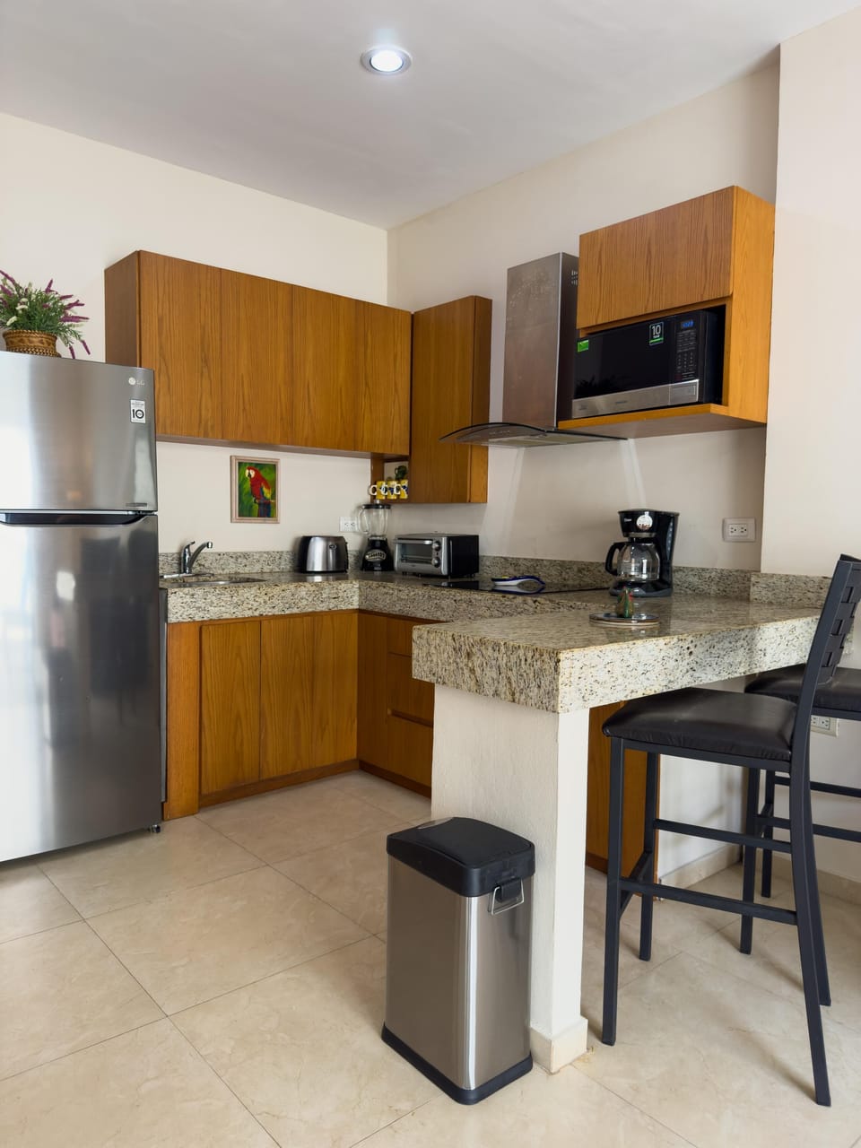 Modern kitchen with sleek appliances and breakfast bar seating
