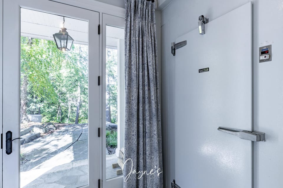 Bright entryway with natural light and garden views