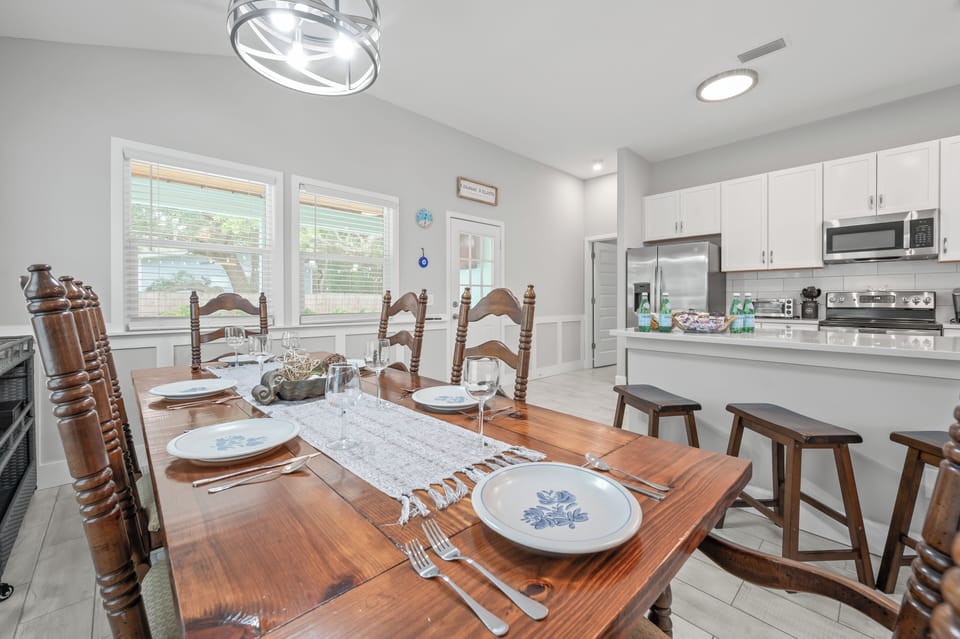 Dining area with seating for six beside the kitchen.