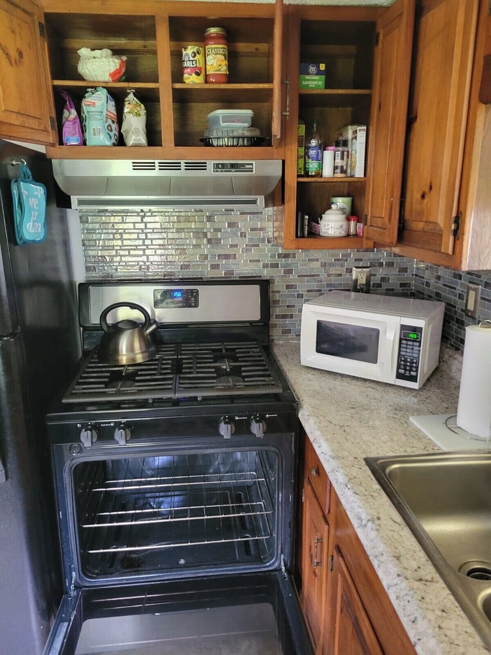 gas stove and microwave and assorted cooking supplies