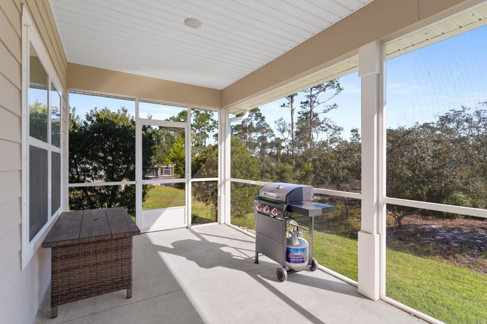 Back porch with propane grill and table.
