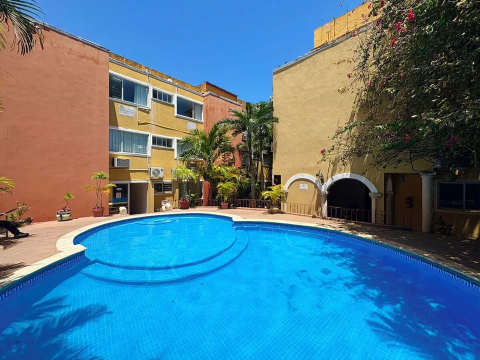 Dive into sunlit serenity in this spacious courtyard pool.