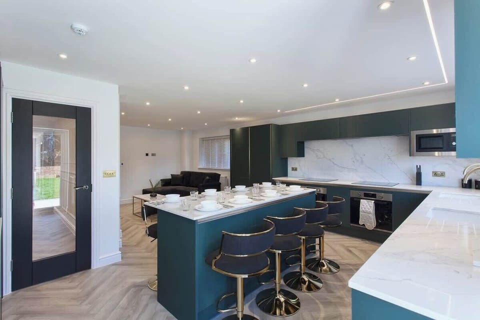 Modern open-plan kitchen with a large island and bar seating, seamlessly connected to the dining area.