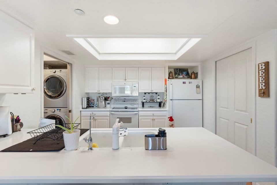 Full kitchen, note laundry room washer and fryer to the left