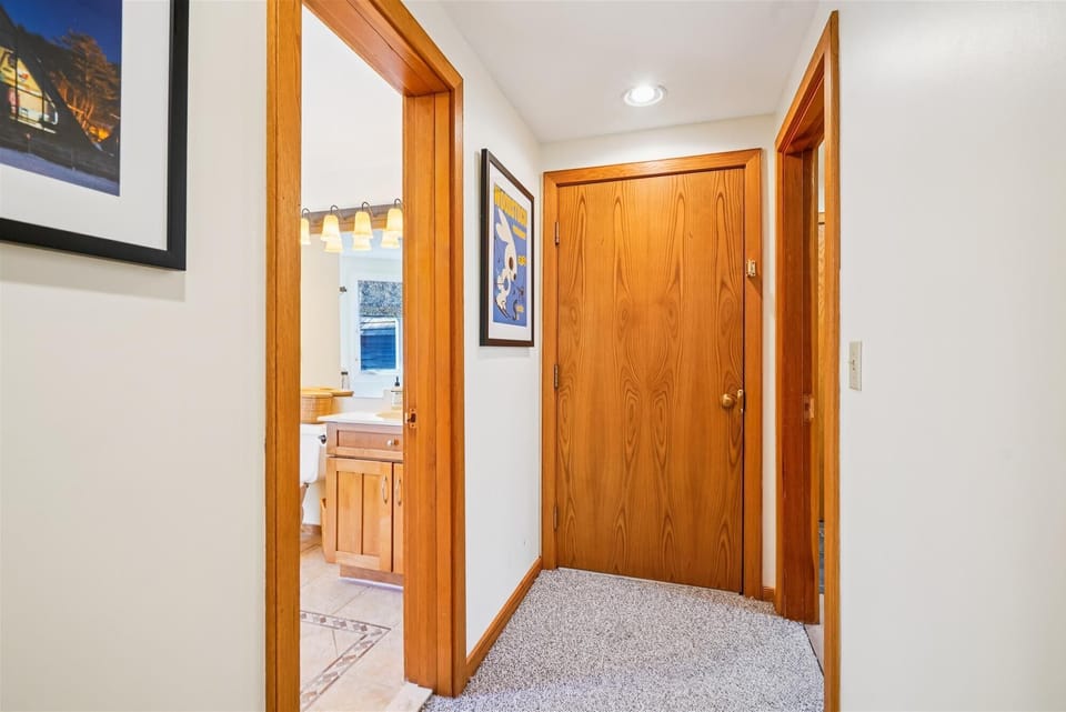 Hallway access to the bathroom and bedrooms within the condo.