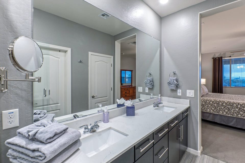 Two can primp in the primary suite bath with dual vanity sinks.