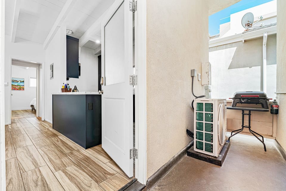 This vacation home includes a small grill and four low-profile beach chairs.
                