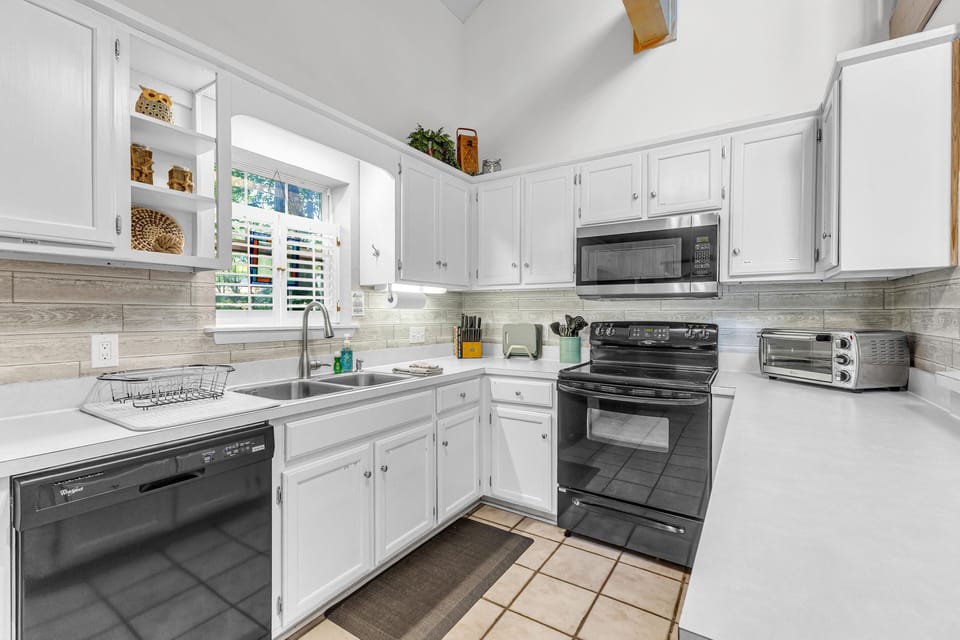 Bright, airy kitchen fully equipped for everything from snacks to family meals.