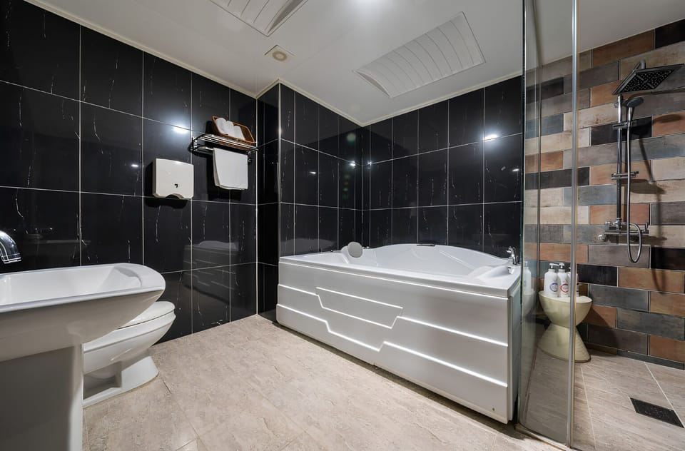 Separate tub and shower, hair dryer, bathrobes, slippers