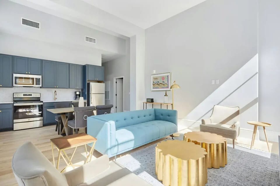 The open-concept living area offers seamless transitions from living to dining and kitchen areas.