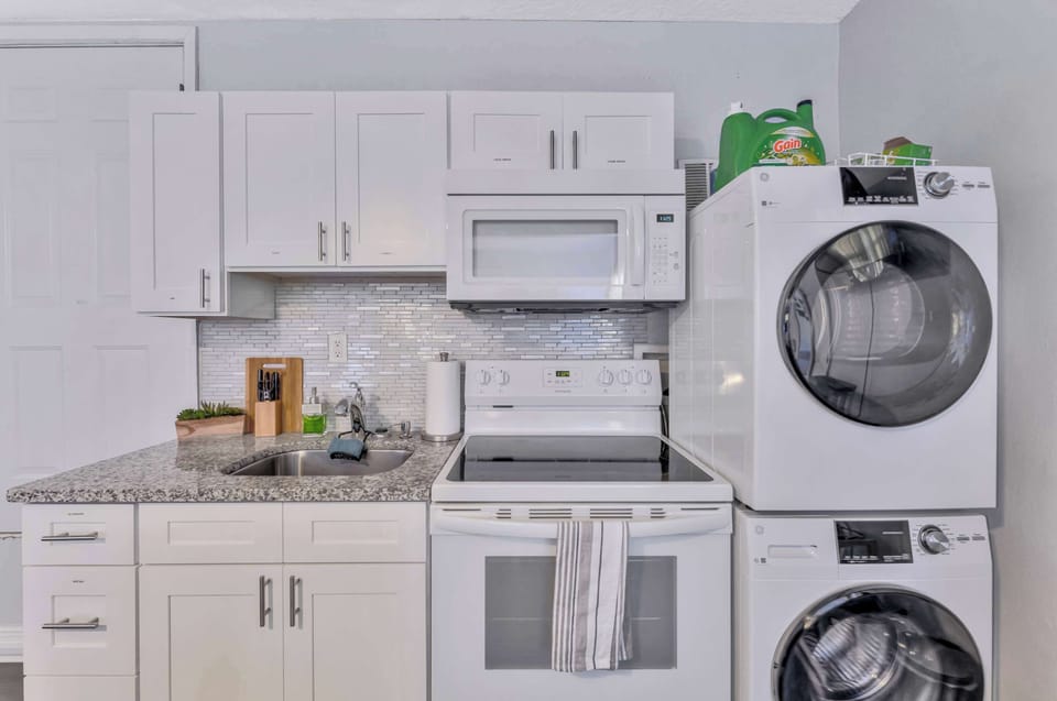 Fully loaded kitchen! Cook, microwave, and do laundry all in one efficient space.