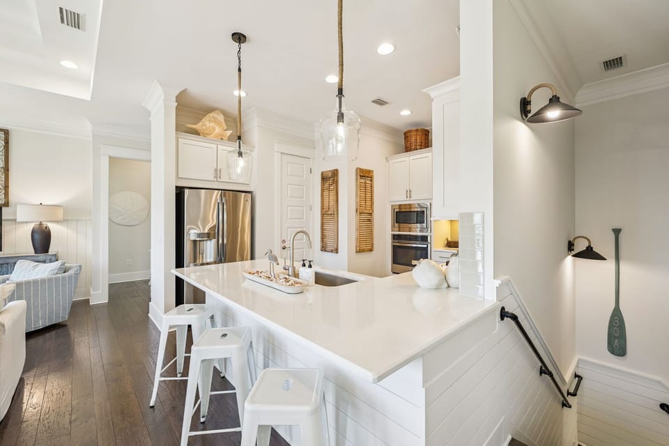 The kitchen is filled with stainless steel appliances and easy to clean surfaces