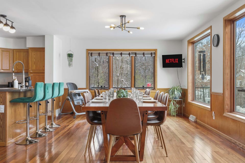 Dining table that seats 12, with 4 barstools in the kitchen, and 6 extra chairs with a fold up table. As well as a rolling high chair.