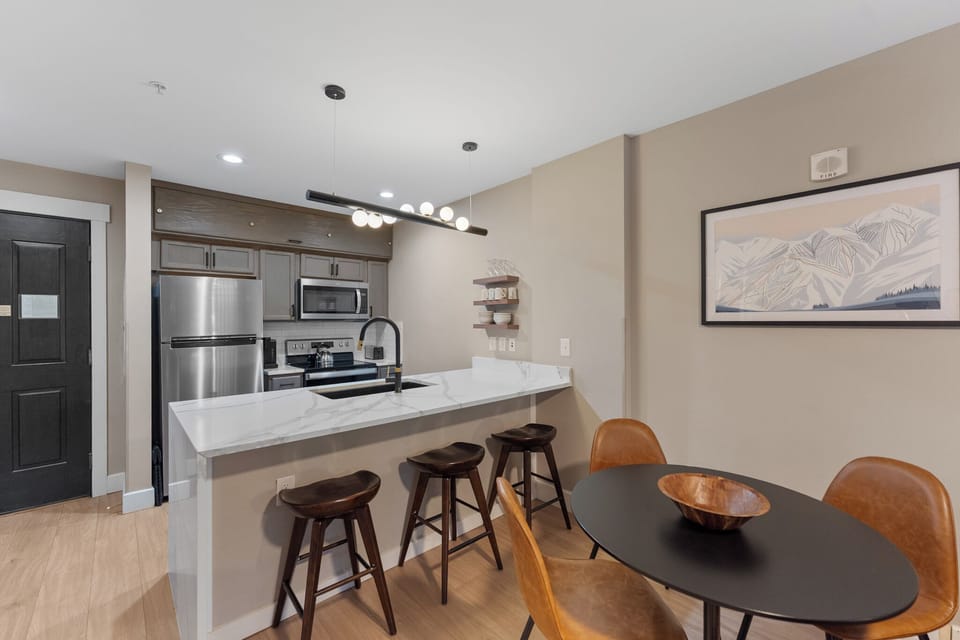 Your open-concept kitchen and dining space features modern appliances, sleek countertops, and stylish seating for memorable meals together.