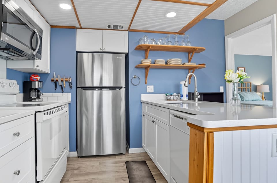 Updated Kitchen with Stainless Appliances - Full-size appliances, bright cabinetry, and open shelving support easy meals during the stay.