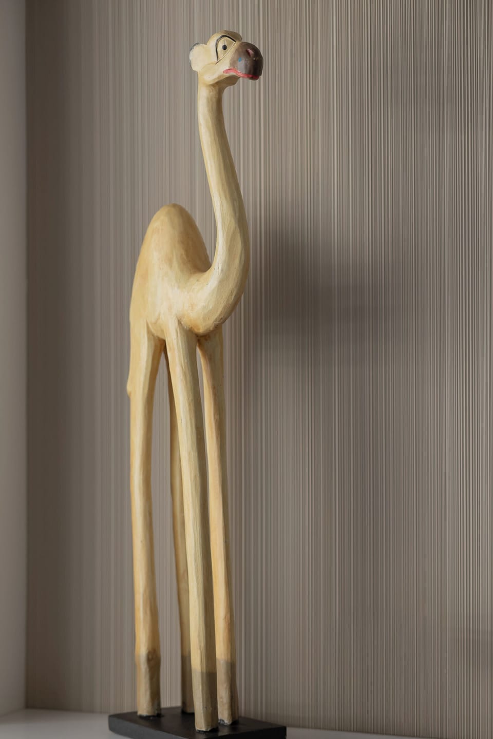 Decorative wooden animal sculpture adding a playful accent to the space.