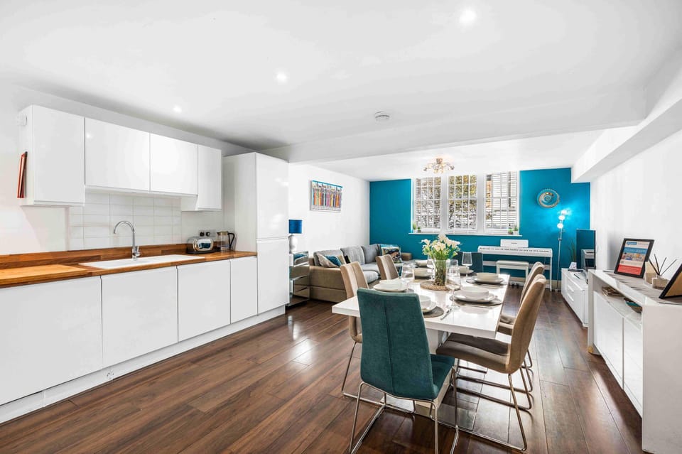 Bright open-plan living area with sofa, dining table, and natural light at Pebbles Reach