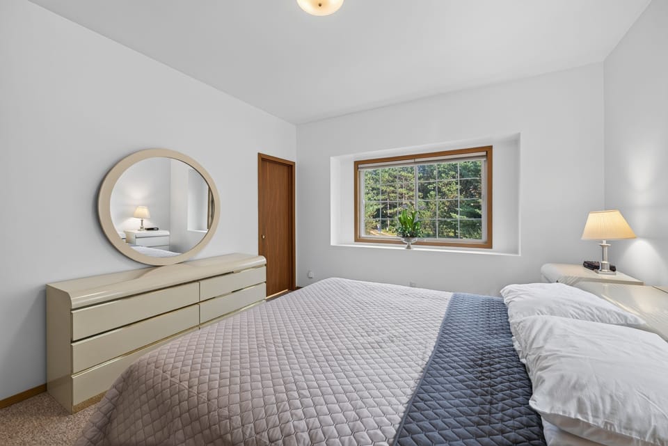 Wake up to serene garden views framed by your bedroom window, where natural light fills the peaceful space and soft linens invite you to unwind completely.