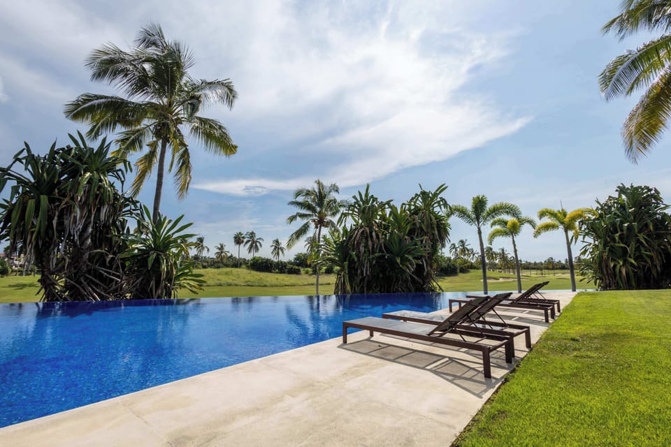 Resort-style shared pool with loungers in a private Punta Mita community