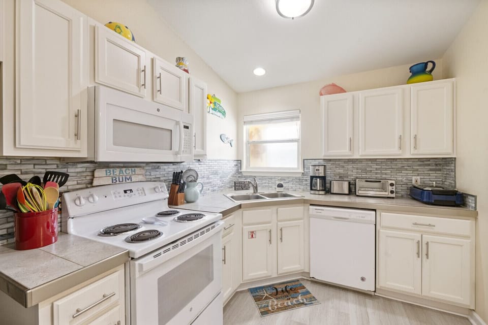 Fully stocked kitchen with seaside colors and charm