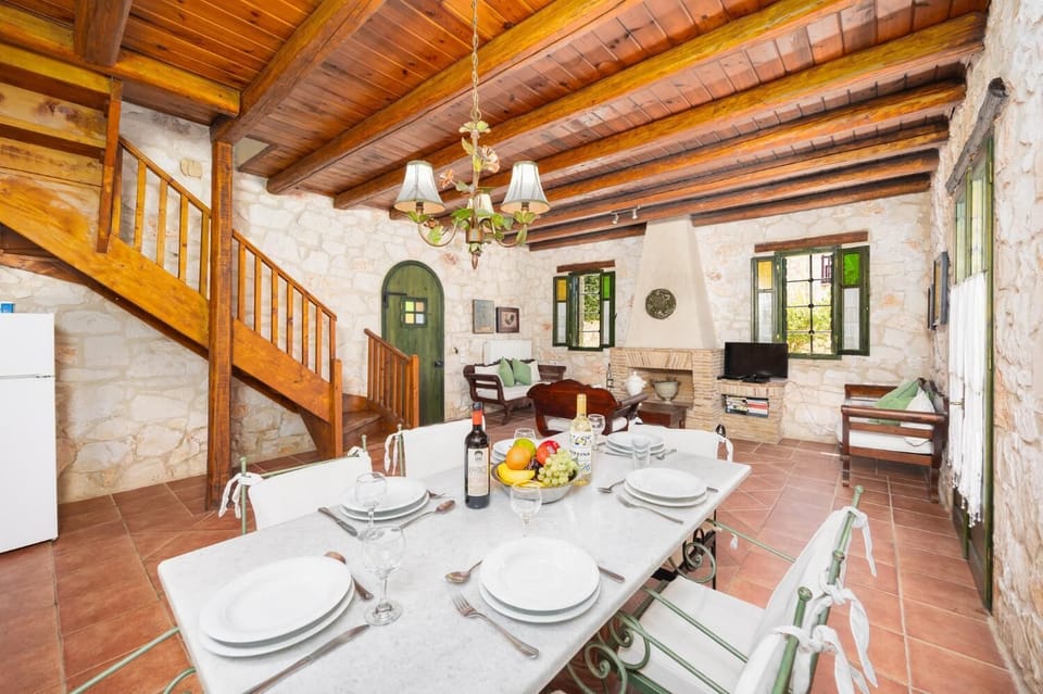 Open-plan living room with sofas, dining area, kitchen, ornamental fireplace, WiFi internet, and satellite TV