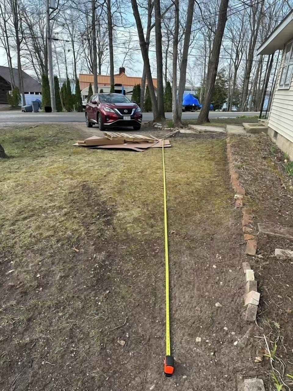 Parking area behind the driveway big enoughfor a boat. Measuring tape shows 25' 