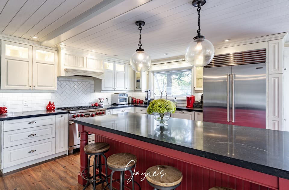 Spacious kitchen with sleek granite island and stainless appliances