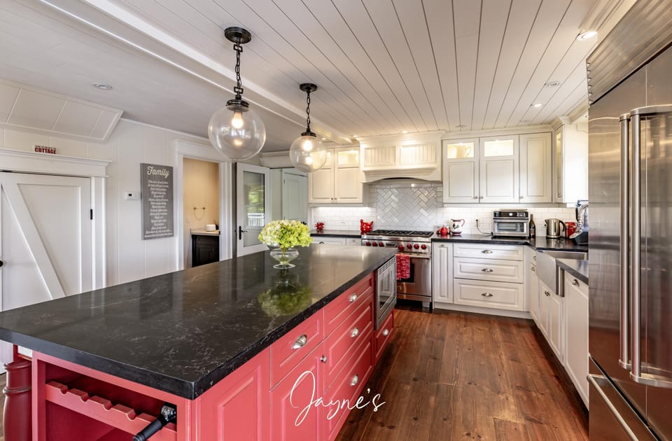 Spacious kitchen with modern appliances and vibrant island