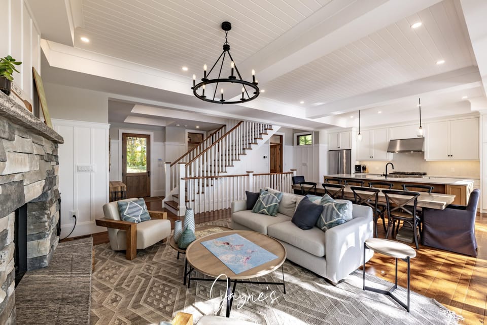 Spacious open-concept living room with cozy fireplace and natural light