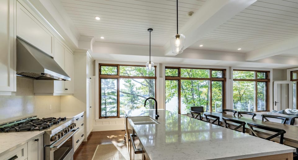 Sunlit kitchen with spacious island and garden views