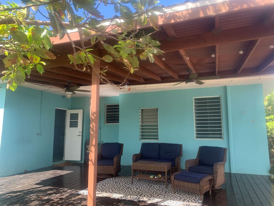 A comfortable outdoor lounge with plenty of seating and a grill ready for use