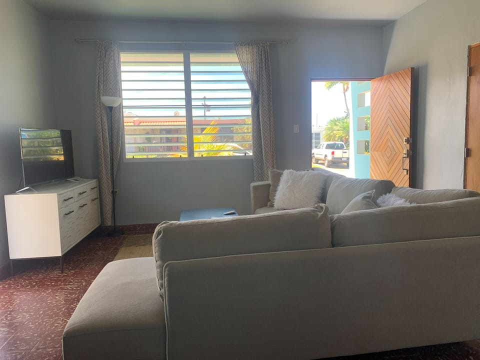 Spacious sofa and plenty of natural light perfect for relaxing together