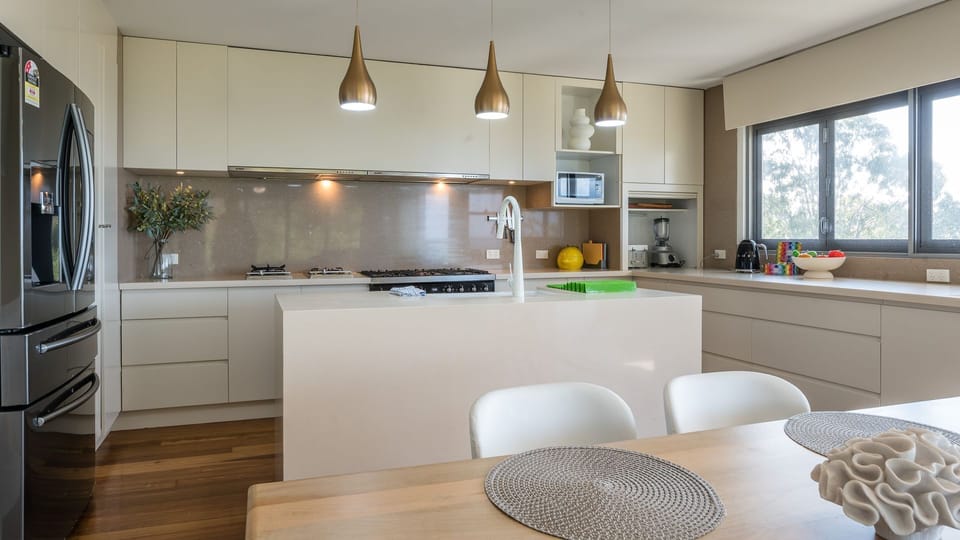 Kitchen with stainless appliances and pendant lights