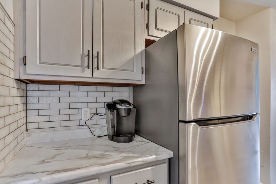 Inviting kitchen with a clean, modern feel, highlighted by neutral cabinetry, stainless steel finishes, and practical prep space.