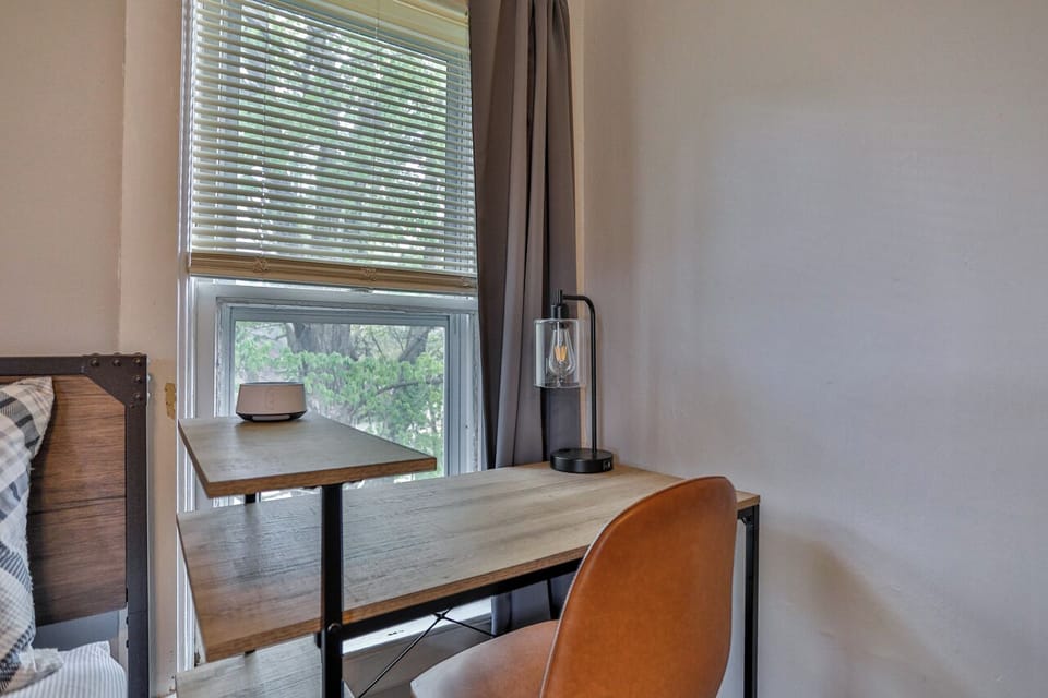 Functional bedroom with added versatility, offering space to sleep, work, and unwind in a comfortable setting.