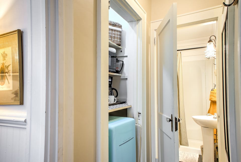 Efficiency kitchen closet with microwave and mini fridge.