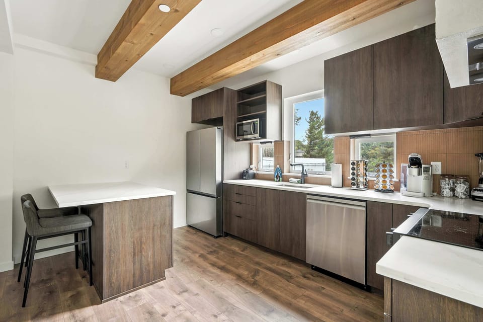 Kitchen with breakfast bar and windows.