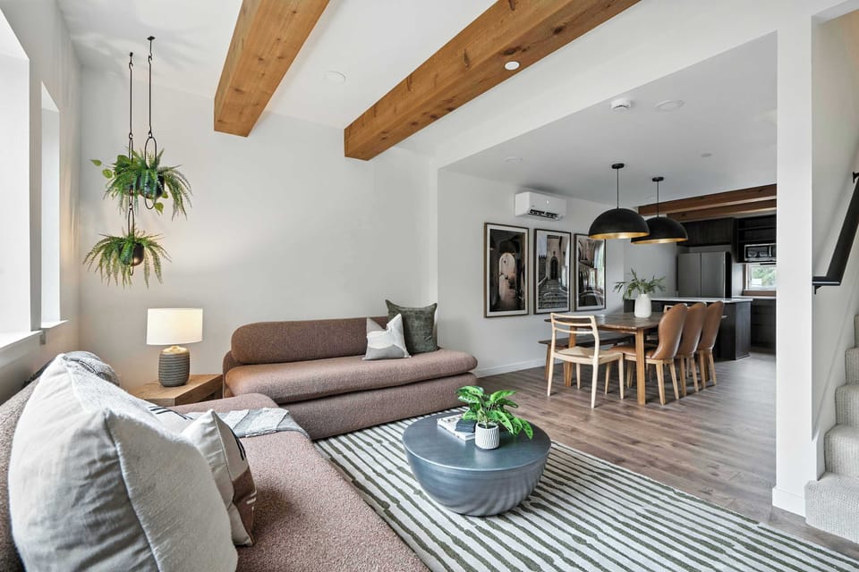 Living room open to dining and kitchen.