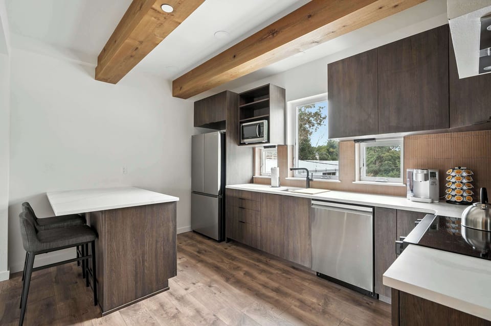 Kitchen with breakfast bar and windows.