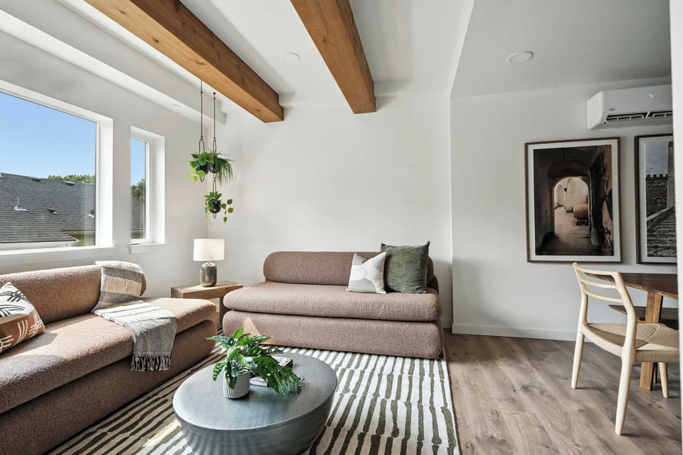 Living area with sofas and a round coffee table.