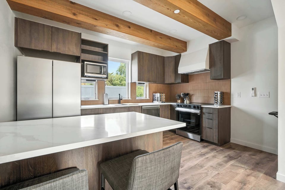 Kitchen with island and stainless appliances.