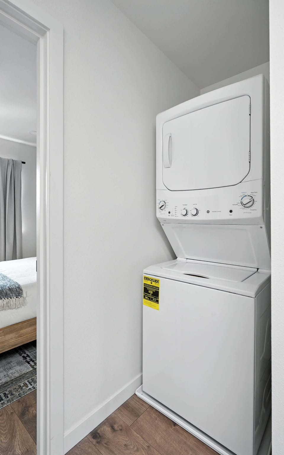 Stacked washer and dryer in a closet.