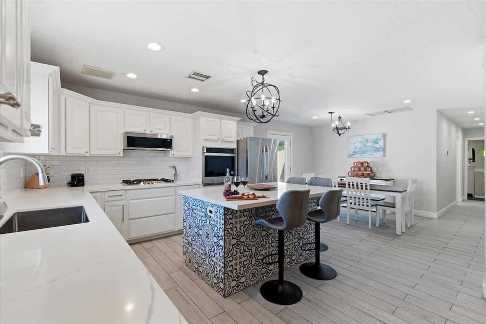 Fully equipped kitchen with stainless steal appliances and a kitchen island with bar seating for 4 guests.