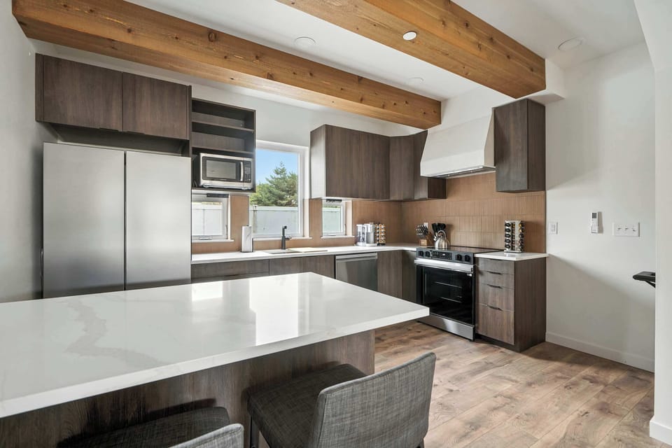 Kitchen with island seating and full appliances.