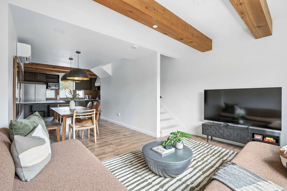 Living room open to dining and kitchen.