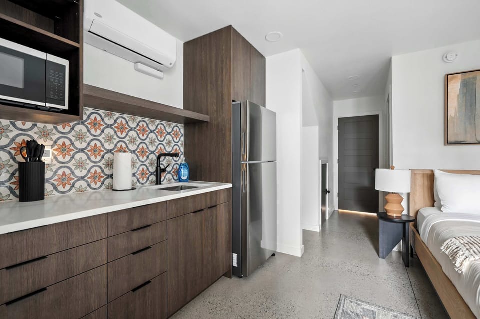 Kitchen counter with patterned tile and hallway beyond.