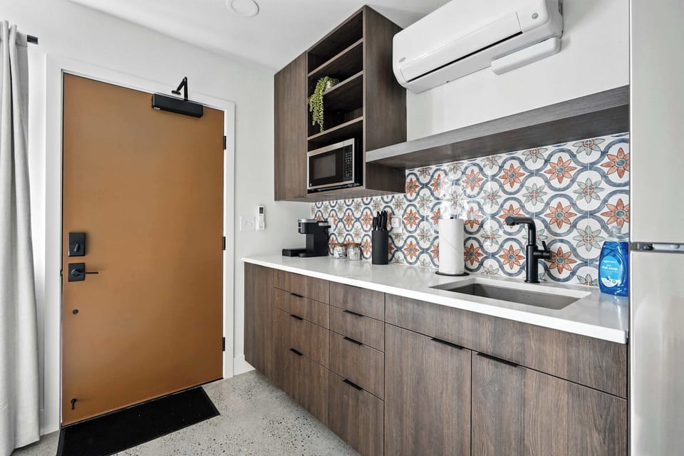 Kitchen counter with sink and front entry.