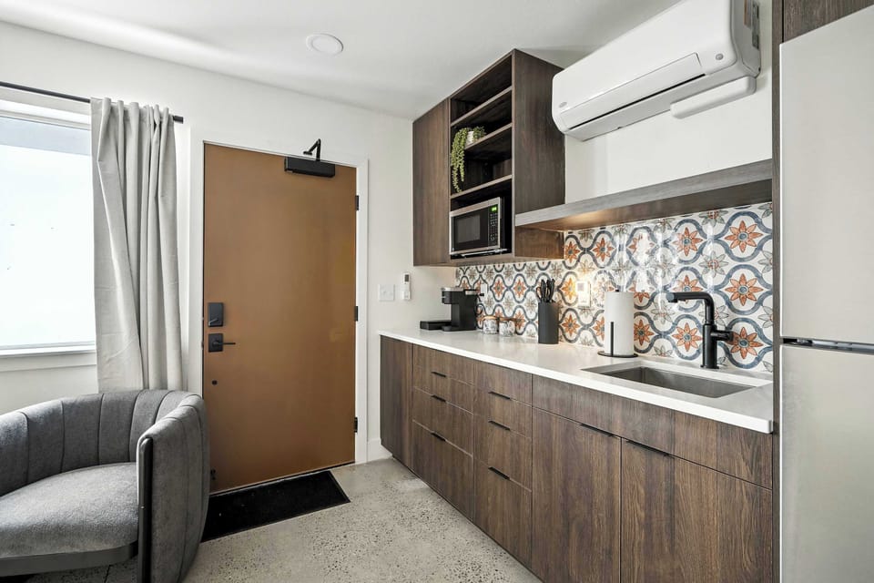 Kitchen counter with patterned tile and entry.