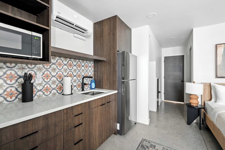 Kitchen counter with tile and hallway.