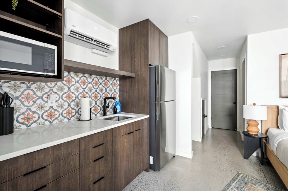 Kitchen counter with patterned tile and hallway.